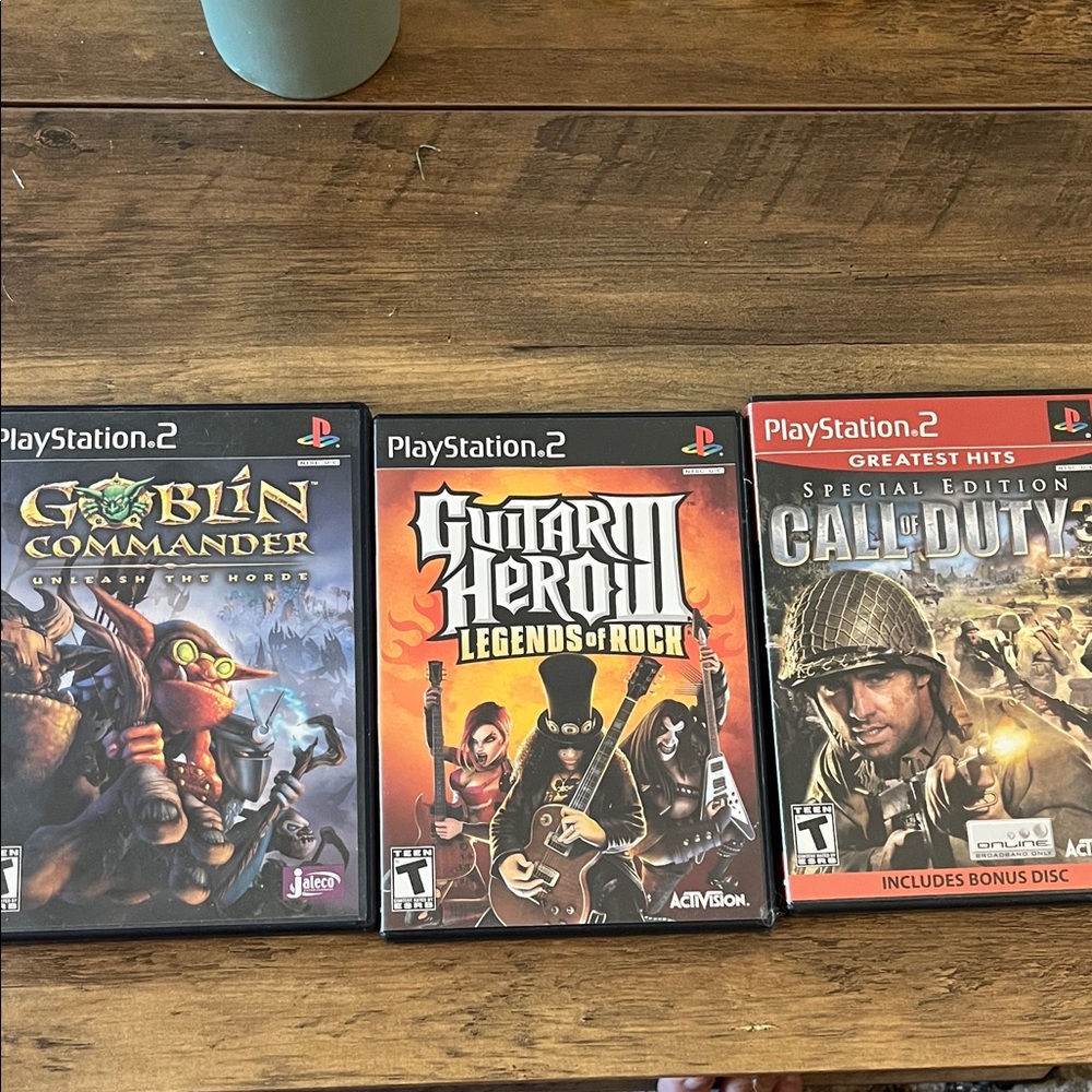 Sony PlayStation 2 Game Trio - Goblin Commander, Guitar Hero III, Call of Duty 2